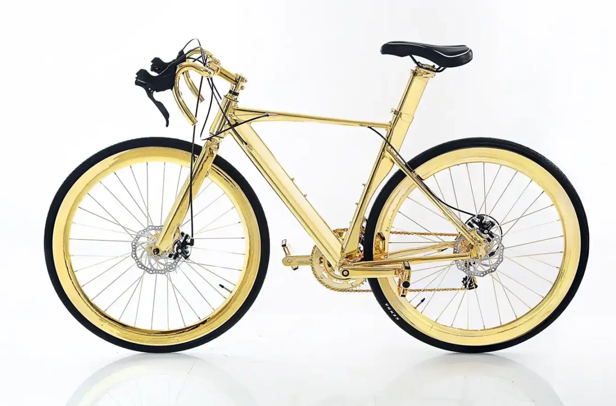 Full side profile of the 24K Gold Racing Bike, gold frame and wheels with black saddle and tyres