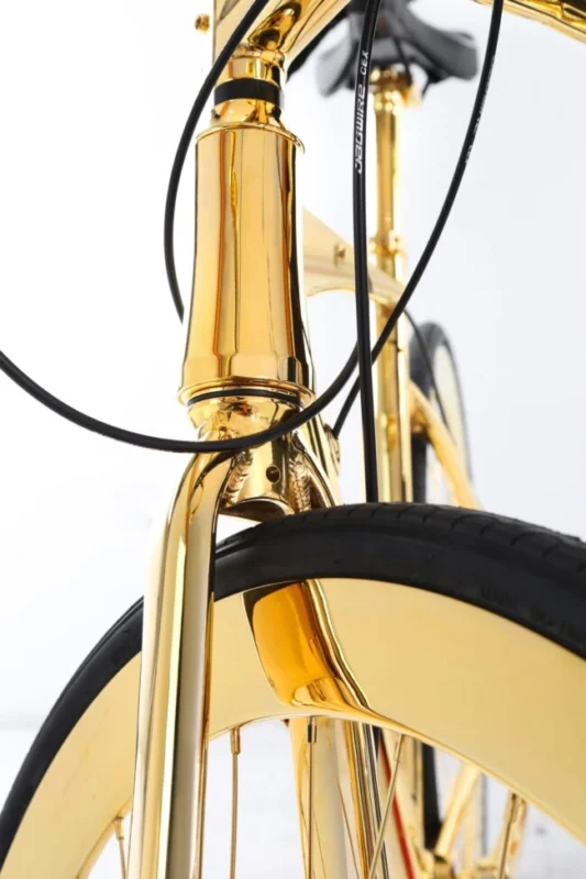 Close-up of the gold-plated handlebars and frame of the 24K gold racing bike