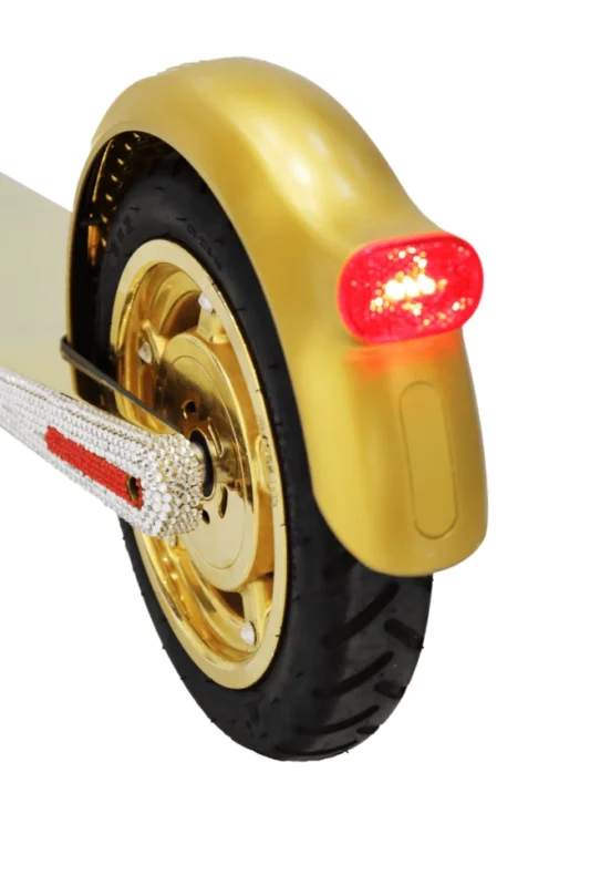 Detail of the gold-plated wheel and rear light of the Royale Rover scooter