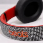 Swarovski Beats Studio Pro crystal work, shown on an earlier Beats Studio model: headband set with dark crystals and the beats wordmark in red crystals
