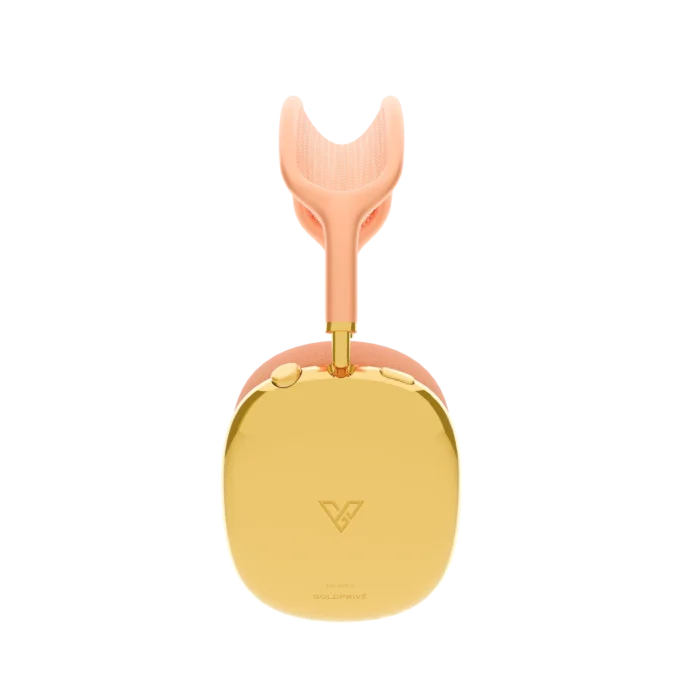Gold AirPods Max 2 Orange from the side, one 24K Gold ear cup with the maker's mark and the gold Digital Crown, the gold arm meeting a peach-orange headband