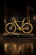 24K Gold Racing Bike on a black display plinth, the gold frame, rims and drivetrain above a black saddle