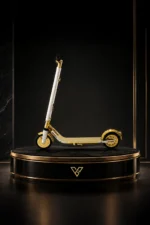 24K Gold Segway on a round black plinth, the gold deck and wheels below a crystal-set steering column