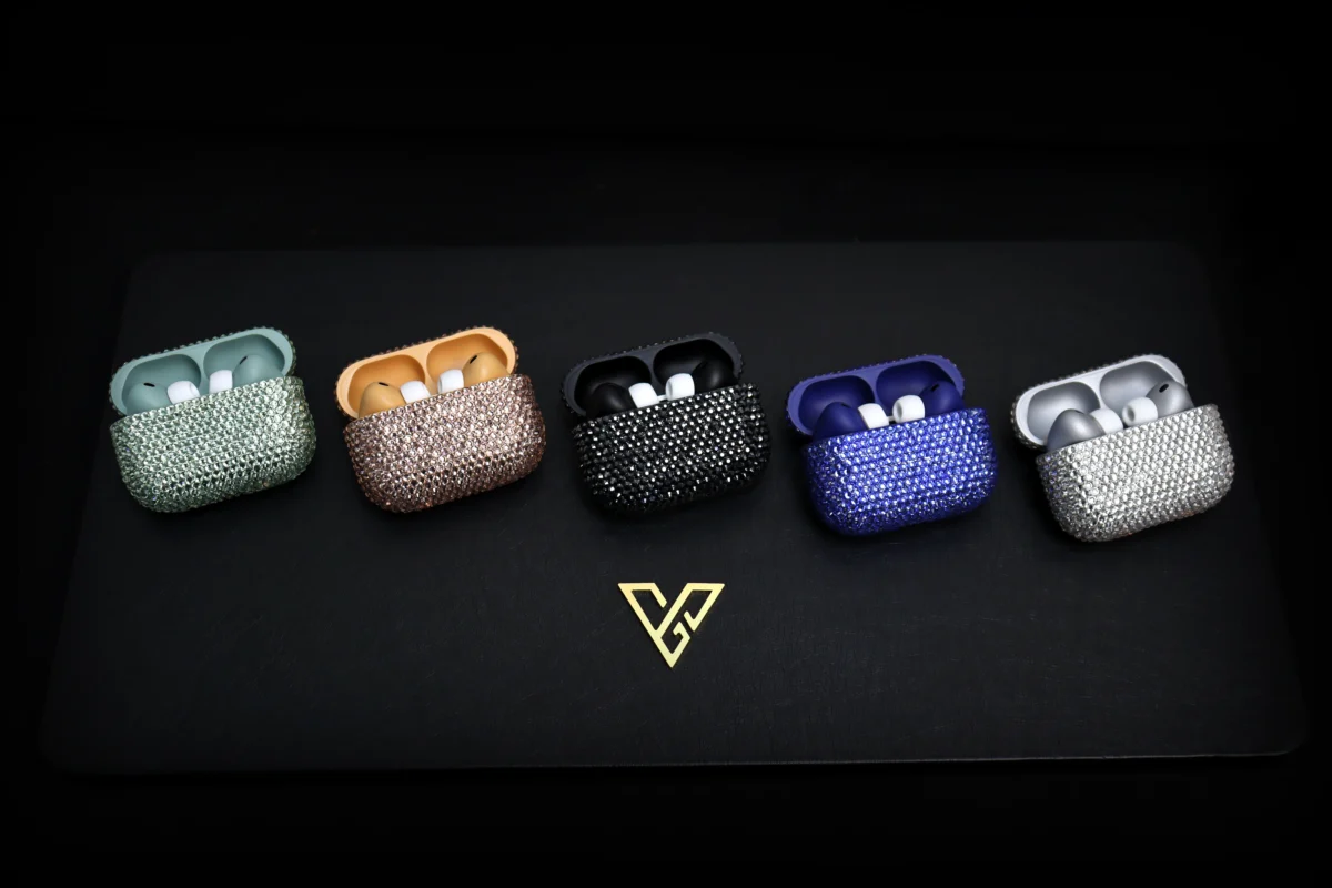 AirPods case covered in red Swarovski crystals inside a black box