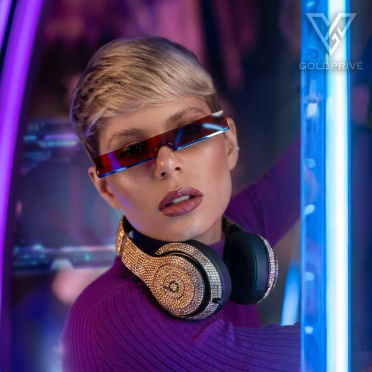 GoldPrivé crystal-set Beats headphones worn by a model in neon light