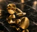 Gold cufflinks on a marble surface, a Leronza gold gift