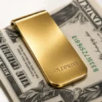 Gold Money Clip seen close over a banknote, the polished 24K Gold face carrying the GoldPrivé mark
