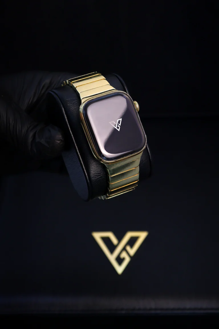 Gold Apple Watch on a black display