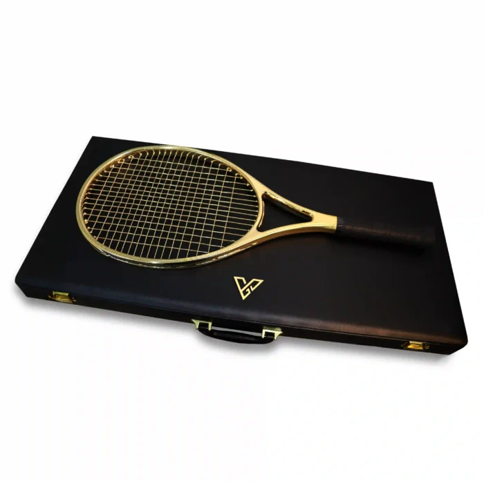 24K Gold Tennis Racket seen from above on the closed leather case, gold strings crossing the oval head beside the gold emblem on the lid
