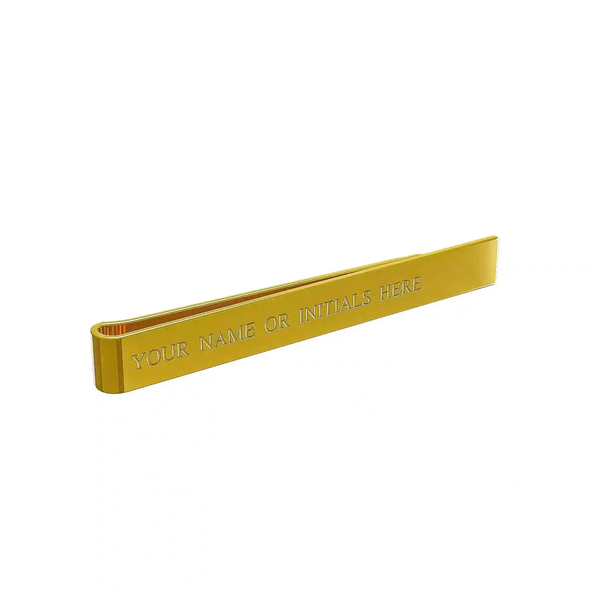Gold tie clip with engraved text, angled view