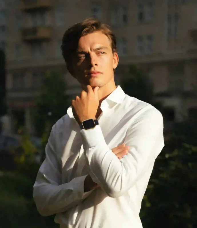 Man in a white shirt wearing a gold Apple Watch